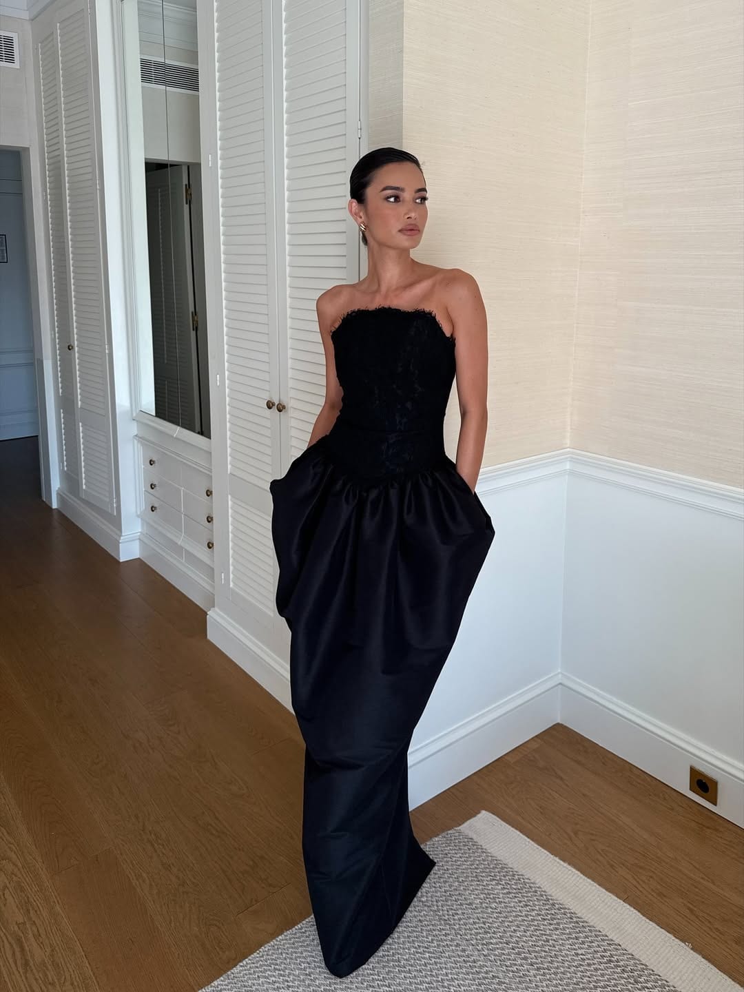 Kelsey Merritt wears a Vania Romoff black dress