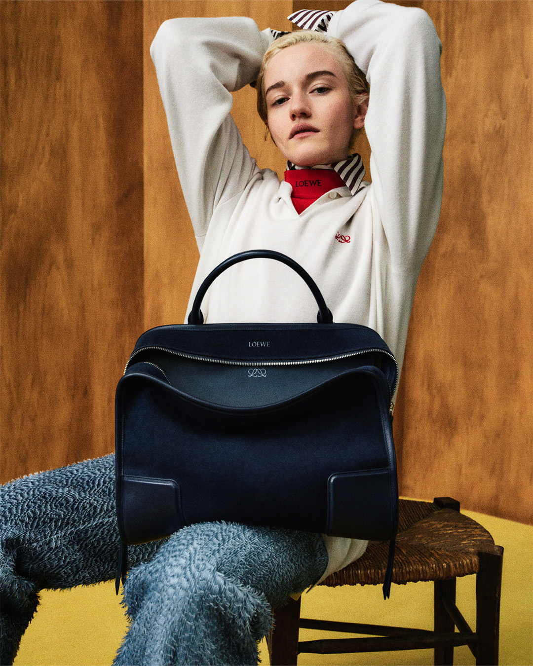 Julia Garner sitting down with a LOEWE bag on her lap
