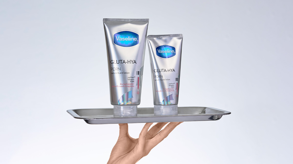 Two bottles of the new Vaseline Gluta-Hya PDRN Body Lotion on a steel tray